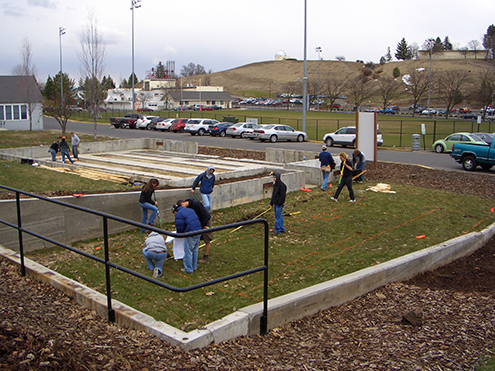 Students working in a grassy area on campus